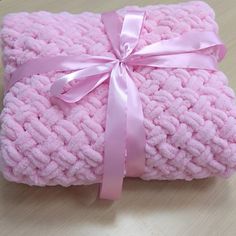 a pink blanket with a bow on it