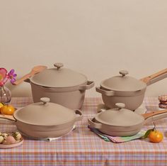 a table topped with pots and pans filled with food