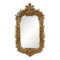 an ornate gold framed mirror with leaves on it's sides and a white background