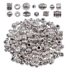 various metal beads and rings on a white background