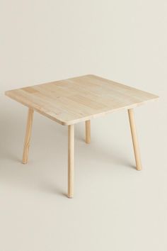 a small wooden table with two legs and a square shaped top, against a white background