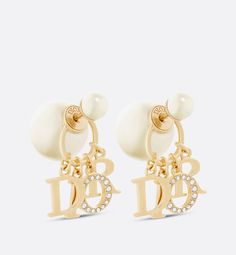 The Dior Tribales earrings offer a new variation on an iconic style of the House. The white resin pearls suspend the letters 'D.I.O.R.' in gold-finish metal, with the letter 'O' in a pavé of crystals. These bold earrings can be paired with other styles from the Dio(r)evolution line.. Crystals Fashion, Wearable Jewelry, Dior Earrings, Crystal Fashion, Jeweled Earrings, Bold Earrings, Dior Jewelry, Luxury Earrings, Christian Dior Couture