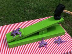 a green object on top of a red and white striped table cloth next to a baseball bat