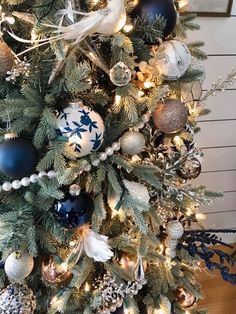 a decorated christmas tree with blue and white ornaments