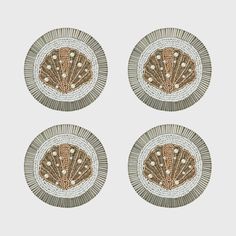 four decorative plates with designs on them