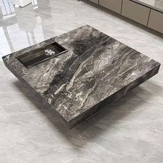 a marble coffee table sitting on top of a white floor in a room filled with furniture