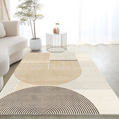 a living room with a white couch and rug on the floor