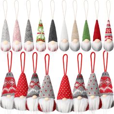 a group of christmas ornaments with santa hats and beards hanging from strings on white background