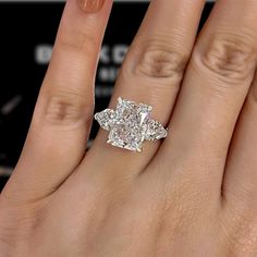 a woman's hand with a diamond ring on it