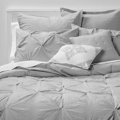 black and white photograph of a bed with pillows