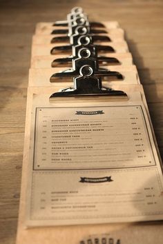 a close up of a menu on a wooden table