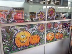 the window is decorated with pumpkins and flowers