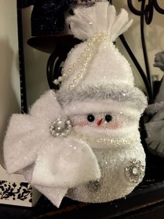 there is a snowman decoration on the shelf