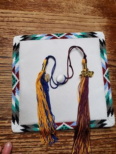 two tassels are placed on top of a piece of cloth