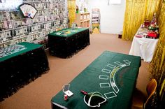 a room filled with lots of tables covered in green tablecloths and black chairs