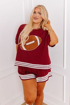 - Be ready for touchdowns and tailgates with this sparkling top! Its super cute sequined football design and jersey-style accent stripes are perfect for bringing a bit of glam to game day. Put a trendy twist on sporty style with this adorable piece! Show your team spirit with our vibrant clothing collection inspired by the bold colors of popular college football teams like the Alabama Crimson Tide. - Unlined cotton-blend material - A crew cut neckline - Short sleeves with ribbed cuffs - A brown, Sporty V-neck Tops For Football Season, Team-colored Sweatshirt With Ribbed Cuffs For Game Day, Game Day Team-colored Sweatshirt With Drawstring Hood, Kids Athleisure, Vibrant Clothing, University Red Short Sleeve T-shirt For Game Day, Football Season Jersey Short Sleeve T-shirt, Jersey Style, College Football Teams