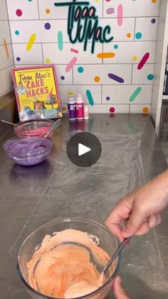 a person mixing something in a bowl on top of a counter next to a sign