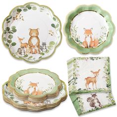 a set of four dinner plates with woodland animals on them and matching napkins,