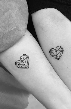 two small tattoos on the arms of women with hearts and diamonds tattooed on their arm