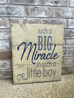 a wooden sign that says, such as a big miracle in such a little boy