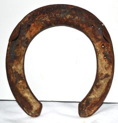 an old rusty horseshoe sitting on top of a white table