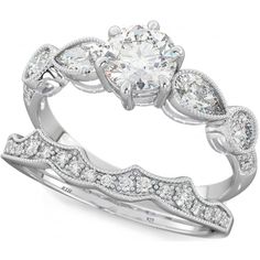 a white gold engagement ring set with three pear shaped diamonds on the band and side stones