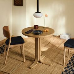 a wooden table with two chairs and a lamp