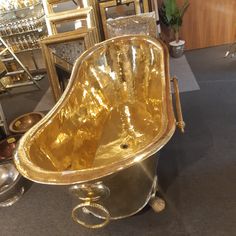 an old fashioned bathtub sitting on top of a floor next to other antique items