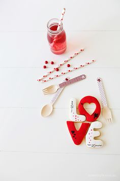 the cookies are decorated with hearts, forks and utensils for valentine's day