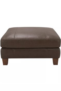 a brown leather ottoman with wooden legs