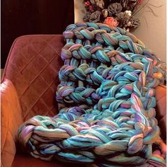 a pile of yarn sitting on top of an orange chair