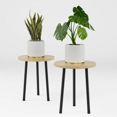 two white planters with black legs are sitting next to each other on small tables