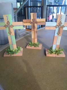 three wooden crosses sitting on top of a table