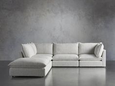 a white couch sitting on top of a gray floor