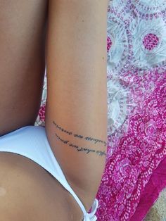 a woman with a tattoo on her left arm and lower half of her body is laying down