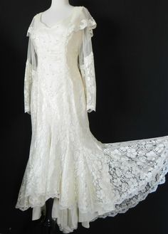 a white dress with sheer sleeves and lace