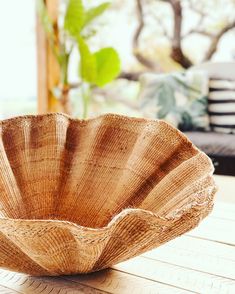 a wooden bowl sitting on top of a table