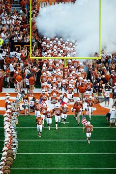 the football team is running onto the field