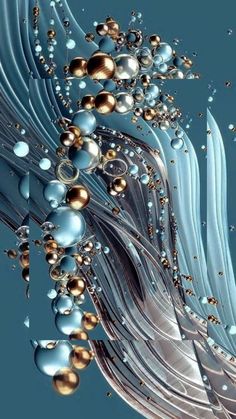 an abstract image of blue, silver and gold balls in the air with water droplets