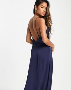 a woman in a long blue dress with open back