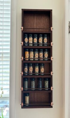 a wooden shelf filled with lots of jars