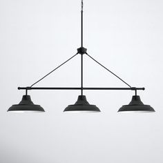 three lights hanging from a ceiling fixture in a room with white walls and flooring