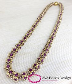 a purple and gold beaded necklace on a white surface with the words ava beads design