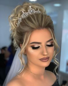 a woman wearing a tiara and makeup