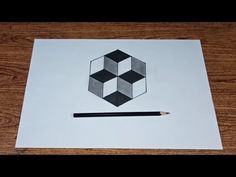 a piece of paper with some black and white squares on it, next to a pencil