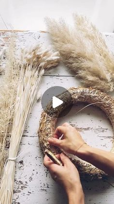 someone is making a wreath out of dried grass and other things to make it look like they're working on something