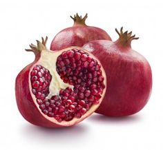 two pomegranates cut in half on a white background