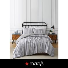 a black and white striped comforter set on a bed in a room with two nightstands