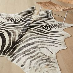 a zebra print rug is on the floor next to a chair