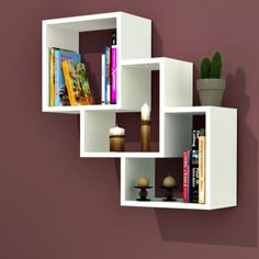 a white shelf with books on it against a purple wall